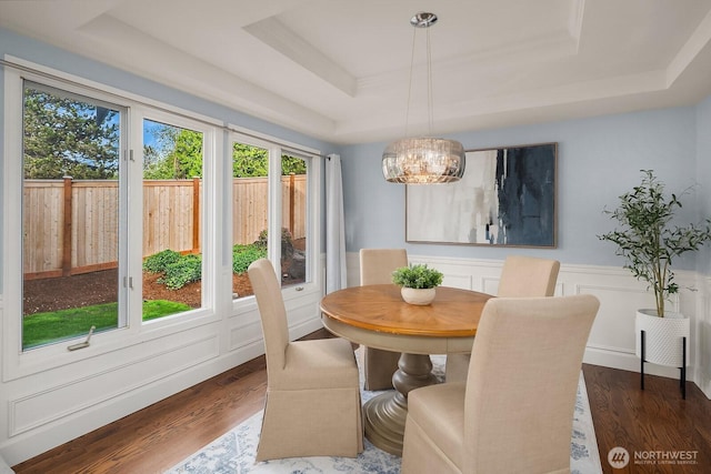 24228 SE 47th St, Sammamish, WA 98029 - dining space featuring a tray ceiling, plenty of natural light, a chandelier, dark wood finished floors, and a wainscoted wall