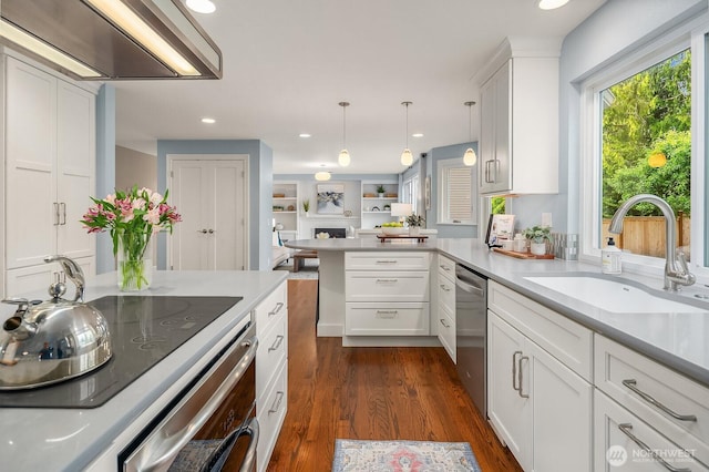 24228 SE 47th St, Sammamish, WA 98029 - kitchen with a sink, dishwasher, light countertops, a peninsula, and dark wood-type flooring