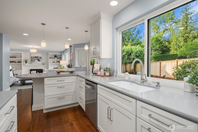 24228 SE 47th St, Sammamish, WA 98029 - kitchen featuring dishwasher, a sink, a peninsula, open floor plan, and light countertops