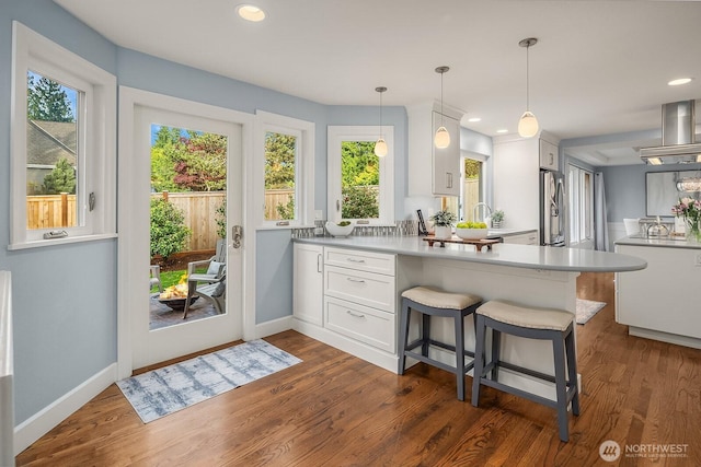 24228 SE 47th St, Sammamish, WA 98029 - kitchen featuring dark wood-style floors, white cabinetry, a peninsula, plenty of natural light, and recessed lighting