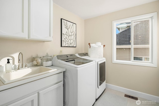 24228 SE 47th St, Sammamish, WA 98029 - washroom featuring washer and dryer, cabinet space, and baseboards