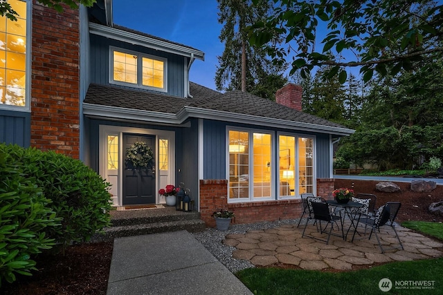 24228 SE 47th St, Sammamish, WA 98029 - doorway to property with brick siding, a patio, a chimney, and board and batten siding