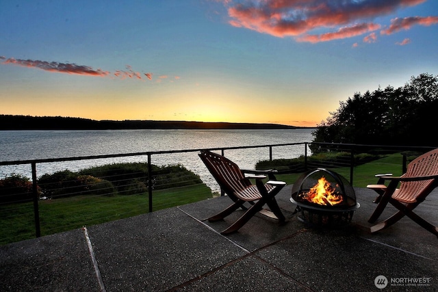4486 E Harbor Rd, Freeland, WA 98249 - balcony at dusk with a fire pit, a water view, and a patio