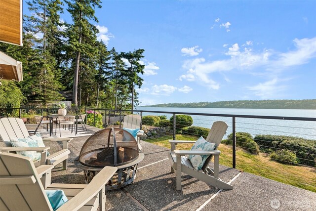 4486 E Harbor Rd, Freeland, WA 98249 - view of patio with an outdoor fire pit, a water view, and a balcony