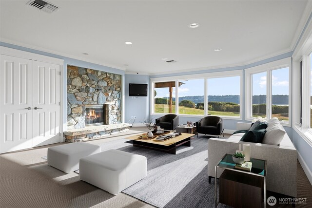 4486 E Harbor Rd, Freeland, WA 98249 - carpeted living area with a stone fireplace, ornamental molding, recessed lighting, and baseboards