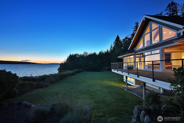 4486 E Harbor Rd, Freeland, WA 98249 - yard at dusk with a lawn and a deck with water view