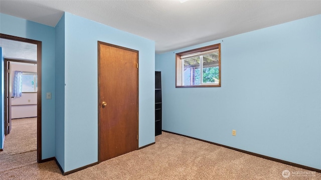 842 W Langdon Rd, Walla Walla, WA 99362 - unfurnished bedroom featuring light carpet, a closet, and baseboards