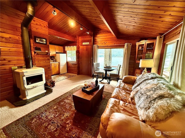 71 N Potlatch Dr N, Hoodsport, WA 98548 - carpeted living room with a wood stove, wooden ceiling, wood walls, and heating unit