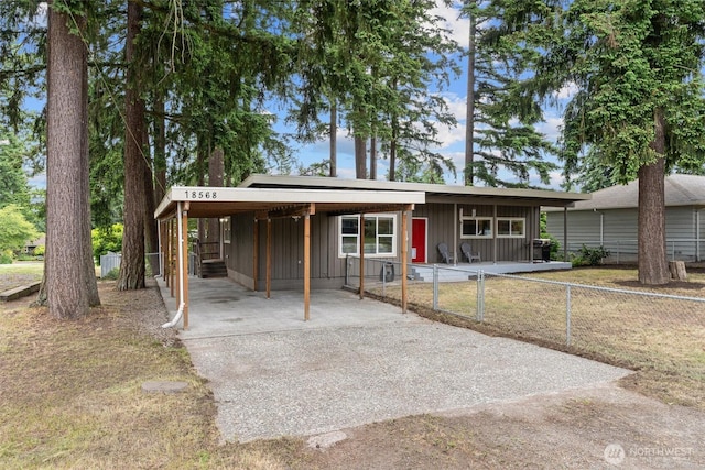 18568 Densmore Ave N, Shoreline, WA 98133 - view of front of house with board and batten siding, concrete driveway, and a carport