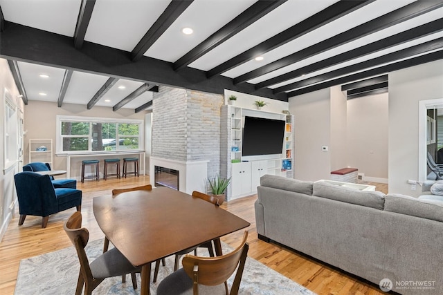 18568 Densmore Ave N, Shoreline, WA 98133 - living area featuring beamed ceiling, light wood-type flooring, a large fireplace, and recessed lighting