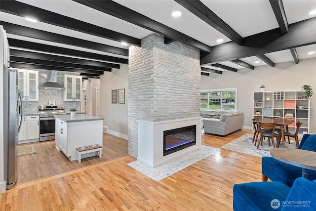 18568 Densmore Ave N, Shoreline, WA 98133 - living area with beam ceiling, light wood-style flooring, a large fireplace, and recessed lighting