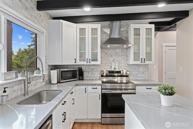 18568 Densmore Ave N, Shoreline, WA 98133 - kitchen featuring wall chimney exhaust hood, appliances with stainless steel finishes, decorative backsplash, white cabinets, and light countertops