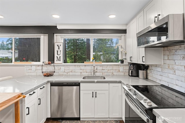 18568 Densmore Ave N, Shoreline, WA 98133 - kitchen featuring stainless steel appliances, white cabinetry, light countertops, backsplash, and recessed lighting