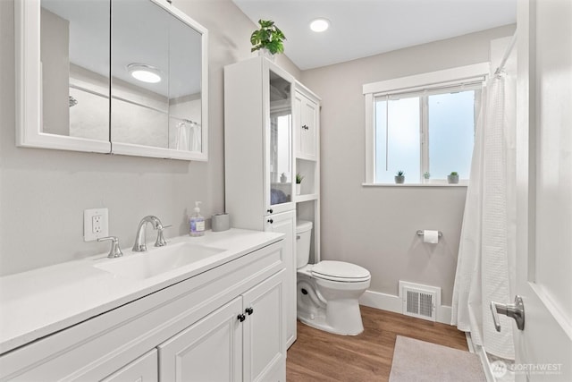 18568 Densmore Ave N, Shoreline, WA 98133 - full bathroom featuring vanity, wood finished floors, a shower with curtain, and recessed lighting
