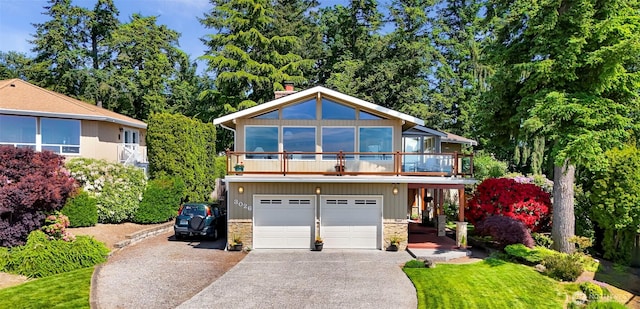3026 E Alpine Dr, Bellingham, WA 98226 - view of front facade featuring concrete driveway, stone siding, a chimney, and an attached garage