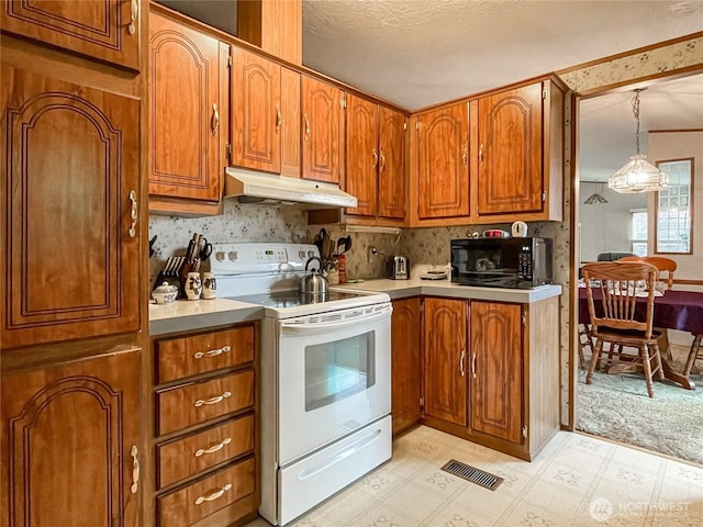 31600 126th Ave SE Unit 129, Auburn, WA 98092 - kitchen featuring under cabinet range hood, electric stove, and brown cabinetry