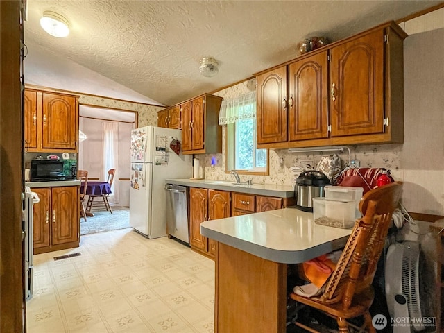 31600 126th Ave SE Unit 129, Auburn, WA 98092 - kitchen with dishwasher, freestanding refrigerator, lofted ceiling, black microwave, and a peninsula