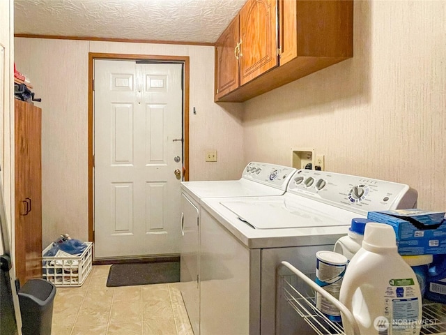 31600 126th Ave SE Unit 129, Auburn, WA 98092 - laundry room featuring independent washer and dryer, cabinet space, a textured ceiling, and light tile patterned floors