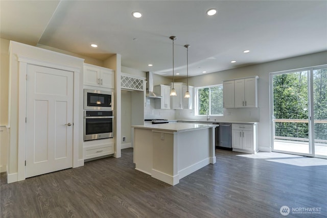 2403 79th Ave SE Unit 110, Tumwater, WA 98501 - kitchen featuring stainless steel appliances, dark wood-style floors, white cabinets, decorative backsplash, and recessed lighting