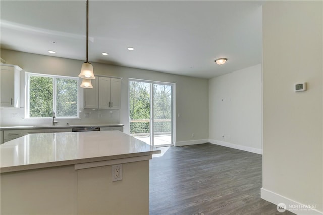 2403 79th Ave SE Unit 110, Tumwater, WA 98501 - kitchen featuring baseboards, backsplash, light countertops, a sink, and recessed lighting