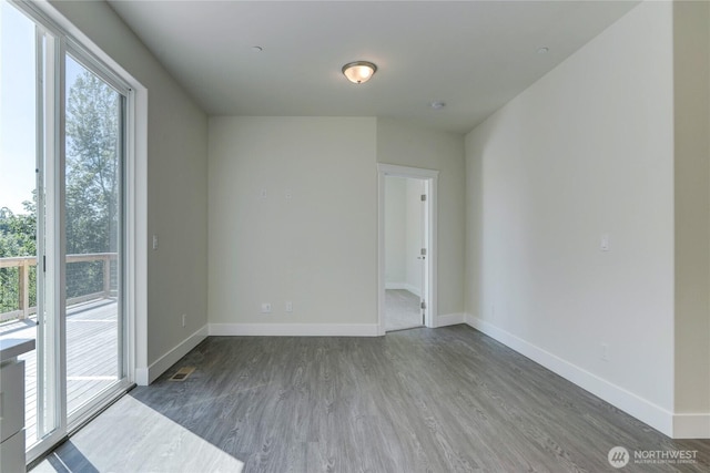 2403 79th Ave SE Unit 110, Tumwater, WA 98501 - unfurnished room featuring wood finished floors and baseboards