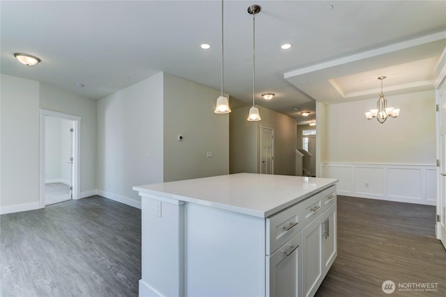 2403 79th Ave SE Unit 110, Tumwater, WA 98501 - kitchen with dark wood finished floors, a chandelier, white cabinetry, a kitchen island, and light countertops