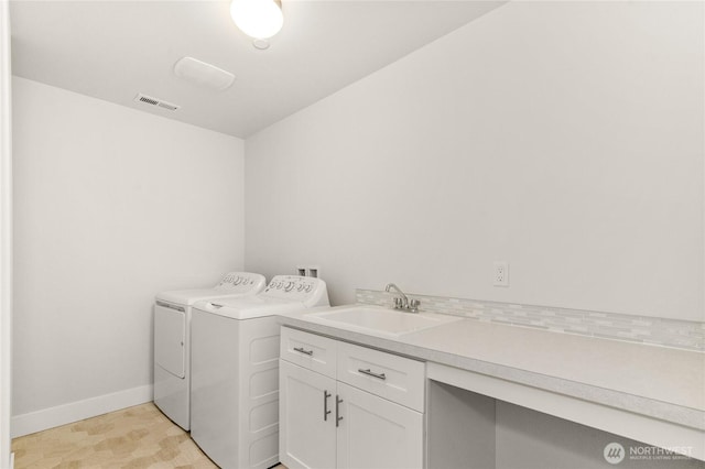 2403 79th Ave SE Unit 110, Tumwater, WA 98501 - laundry room featuring washer and clothes dryer, baseboards, and cabinet space