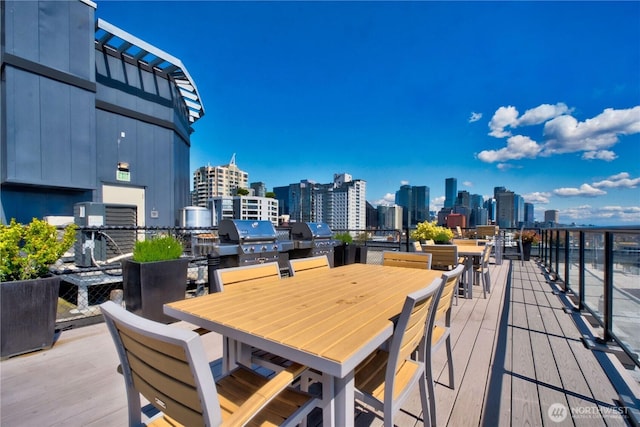2721 1st Ave Unit Ph06, Seattle, WA 98121 - deck with a view of skyline, a grill, and outdoor dining area