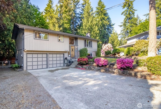 10908 151st St E, Puyallup, WA 98374 - bi-level home featuring driveway, a garage, and a chimney