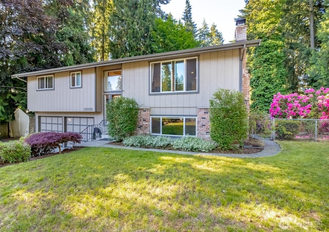 10908 151st St E, Puyallup, WA 98374 - bi-level home featuring a chimney, an attached garage, and brick siding