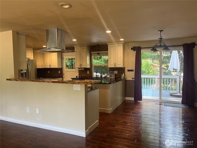 10908 151st St E, Puyallup, WA 98374 - kitchen with island exhaust hood, a peninsula, stainless steel fridge, dark wood-style flooring, and backsplash