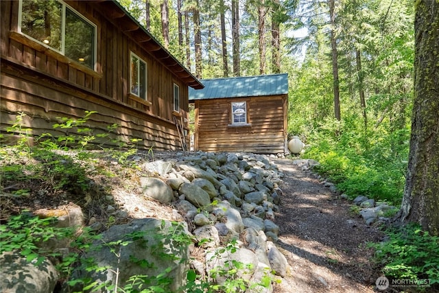 98 Homestead Rd, Winthrop, WA 98862 - view of side of home featuring a wooded view and metal roof