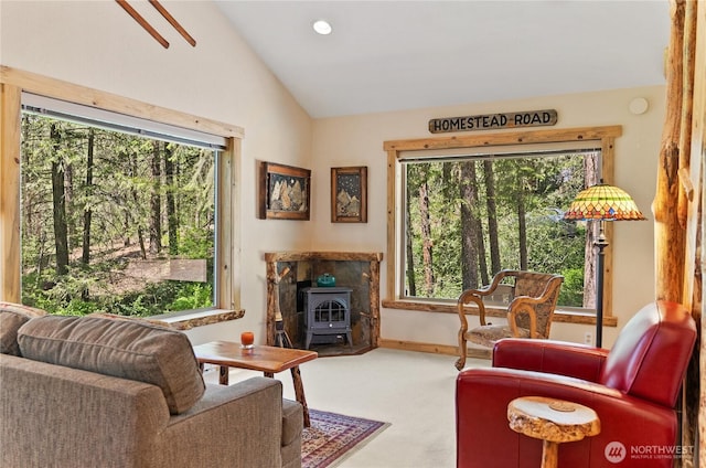 98 Homestead Rd, Winthrop, WA 98862 - living room featuring a wood stove, carpet, vaulted ceiling, healthy amount of natural light, and baseboards