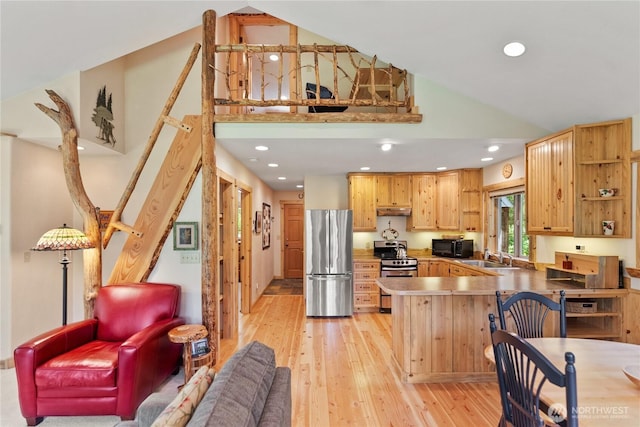 98 Homestead Rd, Winthrop, WA 98862 - kitchen with appliances with stainless steel finishes, high vaulted ceiling, a peninsula, under cabinet range hood, and light wood finished floors