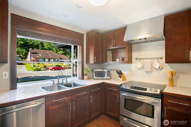 13632 SE Fairwood Blvd, Renton, WA 98058 - kitchen featuring appliances with stainless steel finishes, wall chimney range hood, a sink, and light countertops