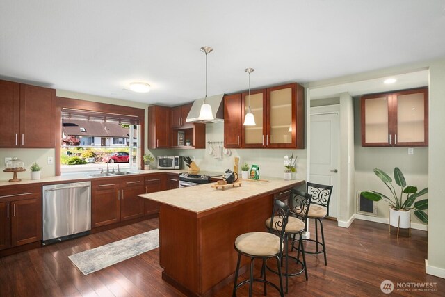 13632 SE Fairwood Blvd, Renton, WA 98058 - kitchen featuring appliances with stainless steel finishes, a sink, dark wood finished floors, a peninsula, and a kitchen breakfast bar