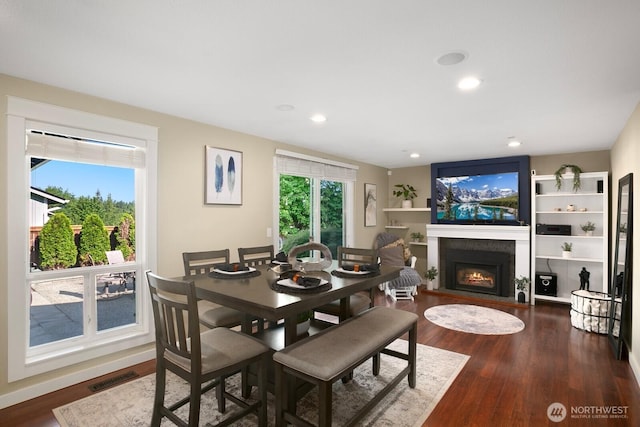 13632 SE Fairwood Blvd, Renton, WA 98058 - dining area featuring a warm lit fireplace, dark wood-type flooring, and recessed lighting