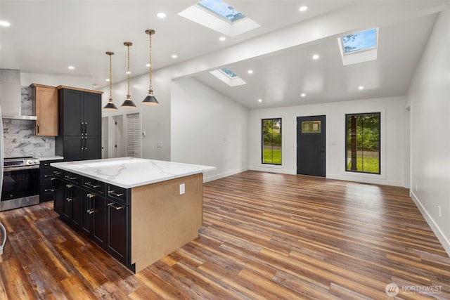4821 S 364th St, Auburn, WA 98001 - kitchen featuring a skylight, stainless steel electric range oven, open floor plan, vaulted ceiling, and dark wood-type flooring