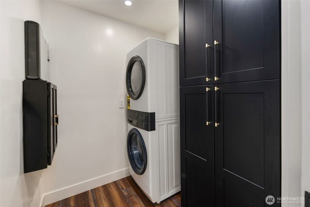 4821 S 364th St, Auburn, WA 98001 - washroom featuring estacked washer and dryer, baseboards, dark wood-type flooring, cabinet space, and recessed lighting