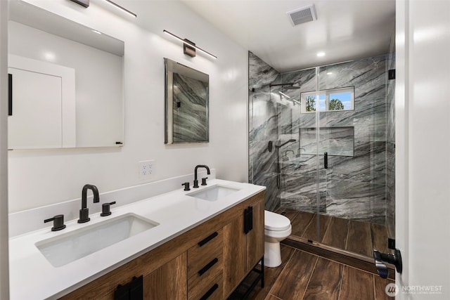 4821 S 364th St, Auburn, WA 98001 - full bath featuring wood finished floors, toilet, double vanity, and a marble finish shower