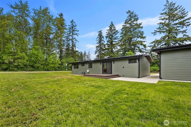 4821 S 364th St, Auburn, WA 98001 - back of property with a wooden deck, a lawn, and a patio