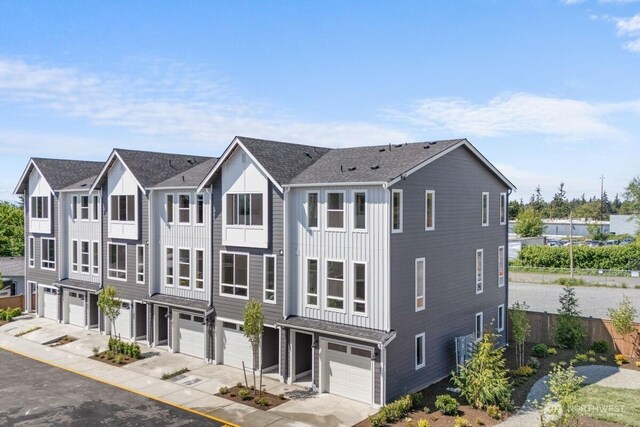 15726 40th Ave W Unit B1, Lynnwood, WA 98087 - multi unit property featuring a garage, driveway, and board and batten siding