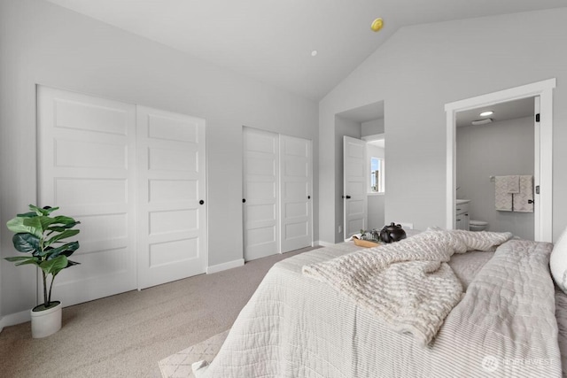 15726 40th Ave W Unit B1, Lynnwood, WA 98087 - carpeted bedroom with multiple closets, ensuite bathroom, baseboards, and high vaulted ceiling