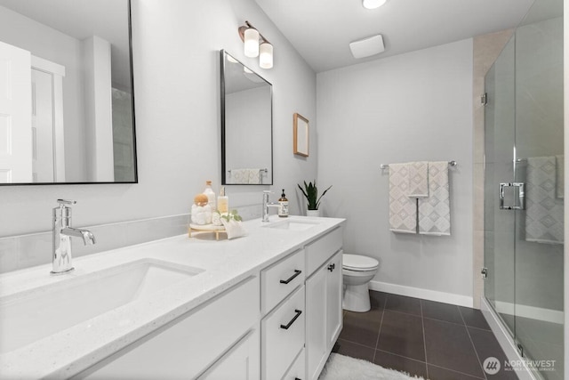 15726 40th Ave W Unit B2, Lynnwood, WA 98087 - bathroom featuring double vanity, tile patterned flooring, a stall shower, toilet, and baseboards