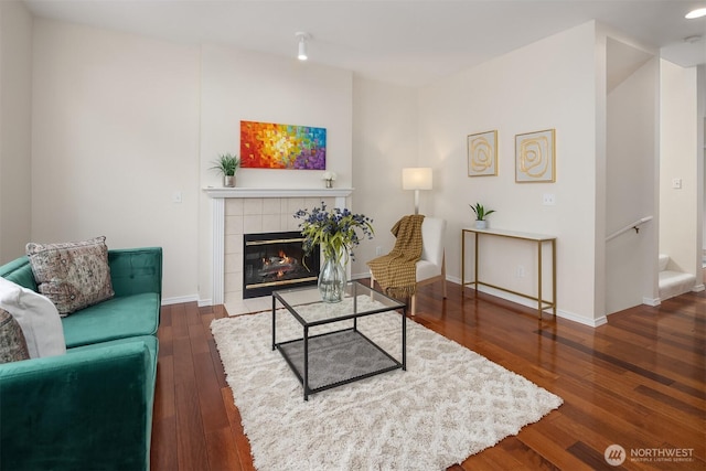 4460 249th Ter SE Unit 4-1, Sammamish, WA 98029 - living room featuring a tiled fireplace, wood finished floors, and baseboards