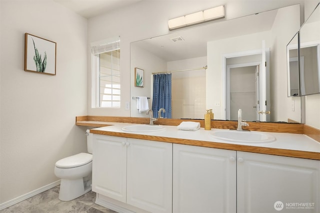 4460 249th Ter SE Unit 4-1, Sammamish, WA 98029 - full bathroom featuring toilet, double vanity, a shower with curtain, and baseboards