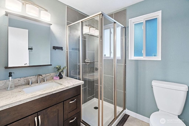 14520 78th Ave NE, Kenmore, WA 98028 - bathroom with toilet, vanity, a shower stall, and tile patterned floors