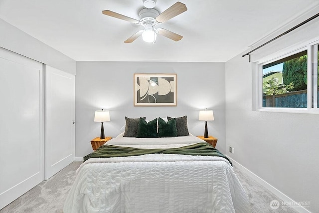 14520 78th Ave NE, Kenmore, WA 98028 - bedroom with baseboards, light carpet, a closet, and ceiling fan