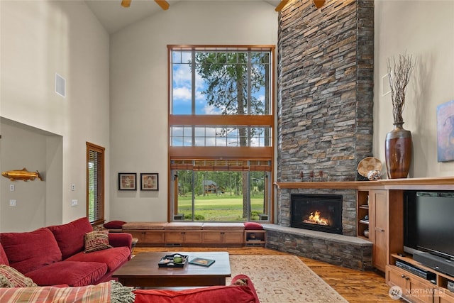2101 Coal Mine Way, Cle Elum, WA 98922 - living room with wood finished floors, high vaulted ceiling, a fireplace, and plenty of natural light