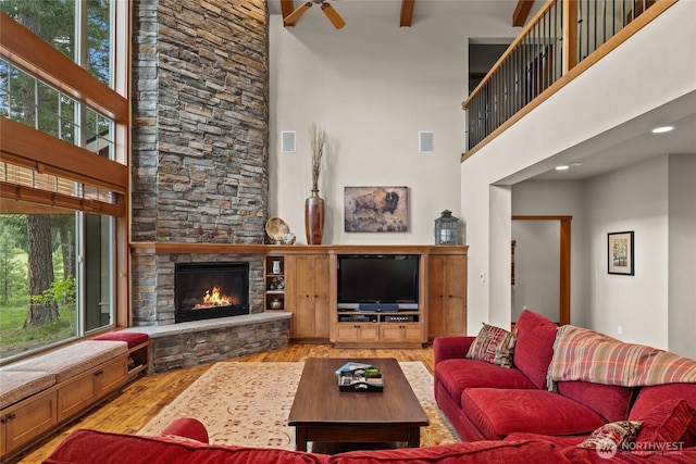 2101 Coal Mine Way, Cle Elum, WA 98922 - living room with wood finished floors, a towering ceiling, a fireplace, and a ceiling fan